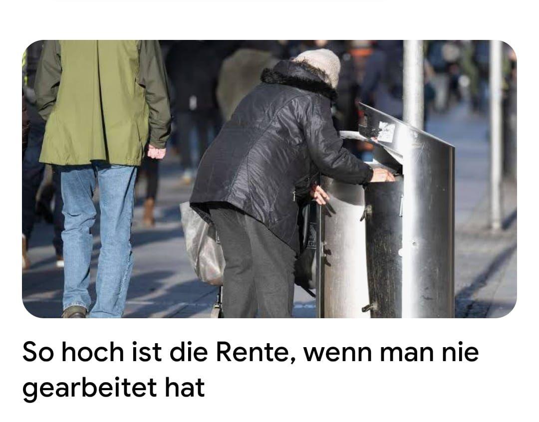 Person in a coat rummaging through a public trash bin on a busy street.